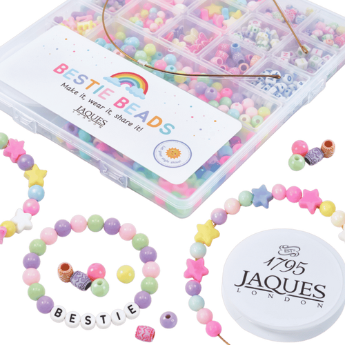 Colorful beaded bracelets and a box of Jaques Bestie Beads on a green background[fill]