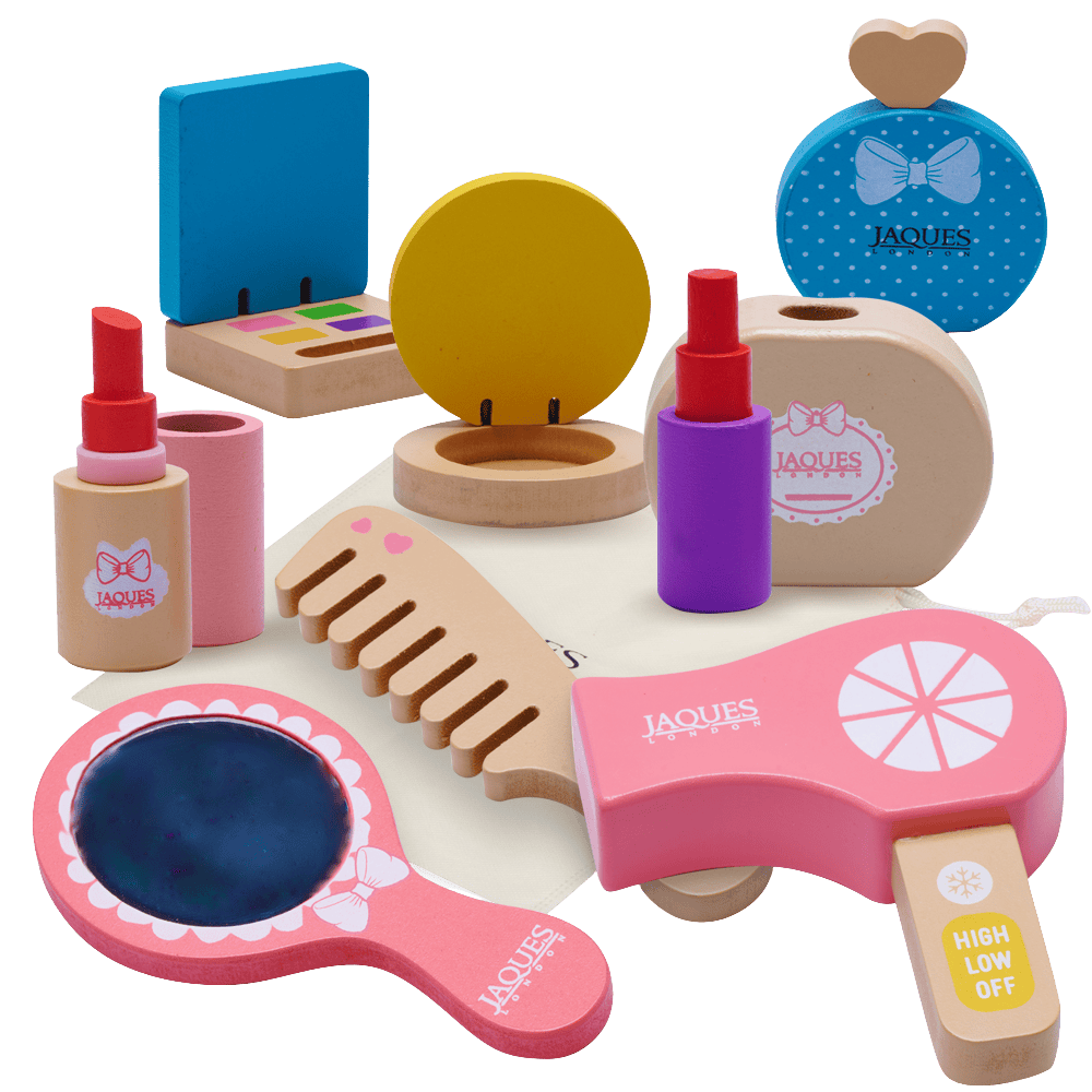Toy makeup set with various items including a mirror, lipstick, and hairbrush on a white background. 