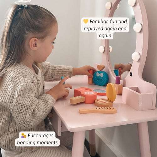 Child playing with a toy vanity set in a room.