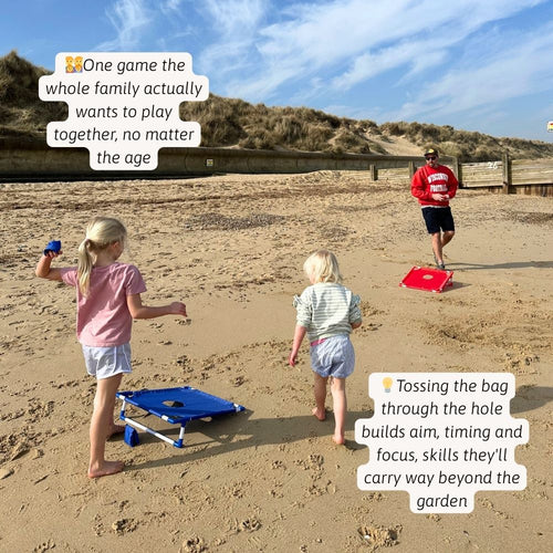 Kids setting up the cornhole board and getting ready to play on the beach. 