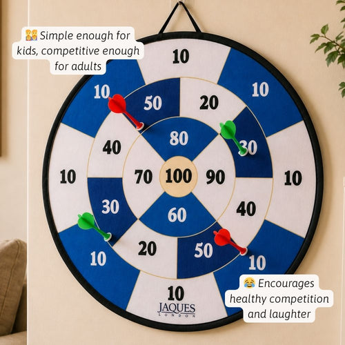 Dartboard with darts on a beige wall, featuring Jaques branding.  