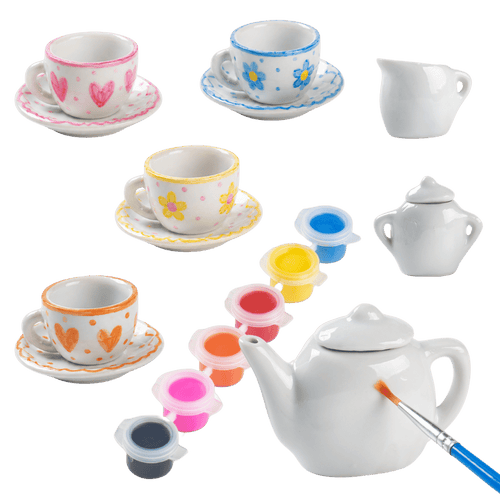 Set of miniature ceramic tea cups, saucers, and teapot with paint containers and brush on a transparent background [fill]
