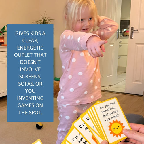 Child in pink pajamas holding a card with text and a sun illustration, in a kitchen setting.