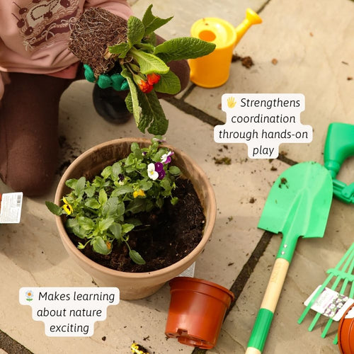 Person planting a small plant in a pot with gardening tools on a concrete surface.