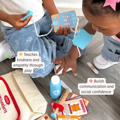 Two children playing with medical toys on a wooden floor. 