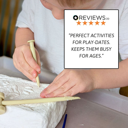 Child carving into the plaster dig block with a wooden tool at a table, with a review quote stating it’s a great activity that keeps kids busy for playdates. 