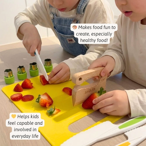 Two children cutting strawberries on a yellow cutting board with kitchen tools. 