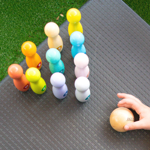 Colourful wooden baby skittles in play 