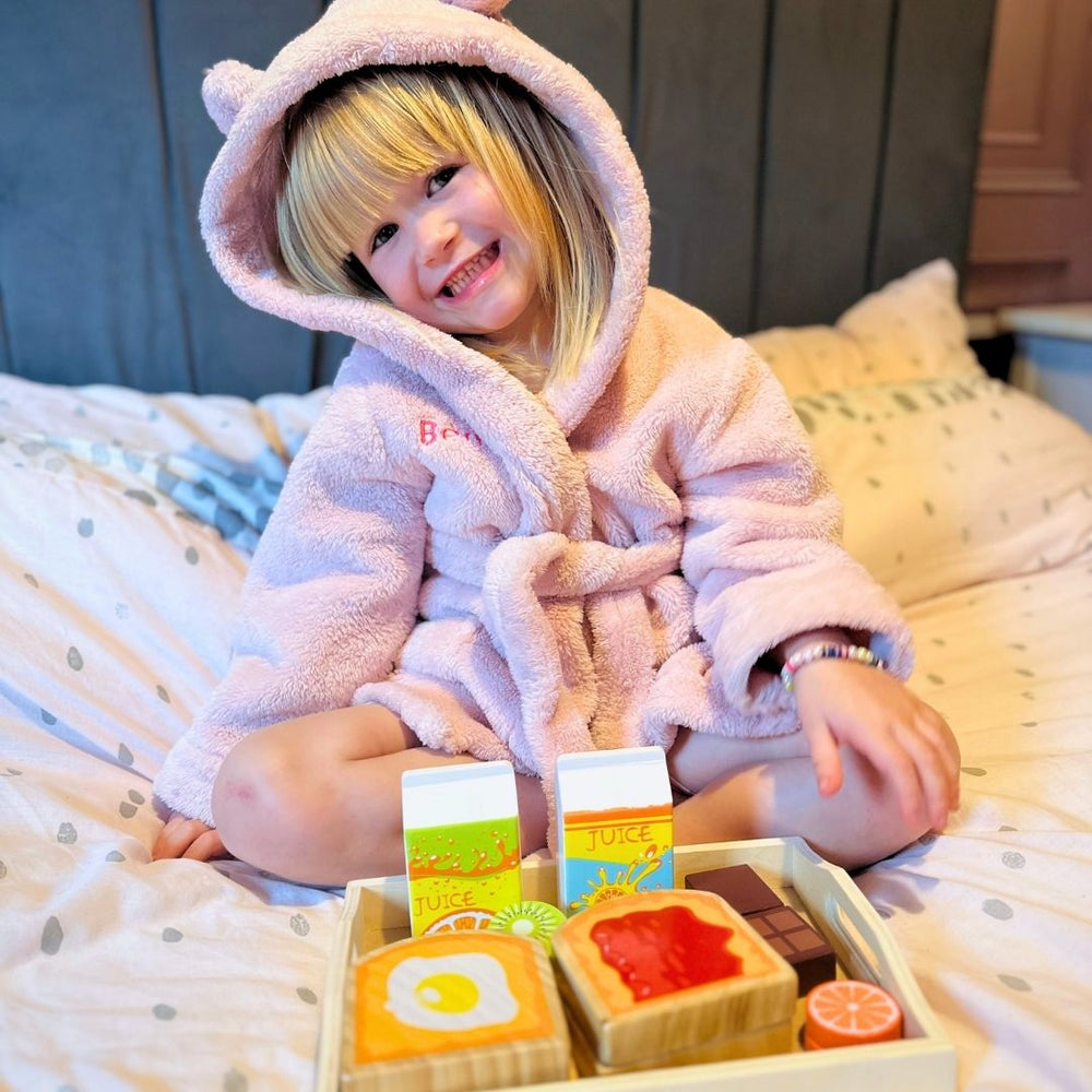 Image of girl sitting on bed with the breakfast in bed playset 