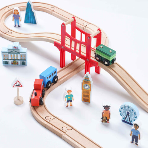Wooden toy train set with tracks, trains, and miniature buildings on a white background 