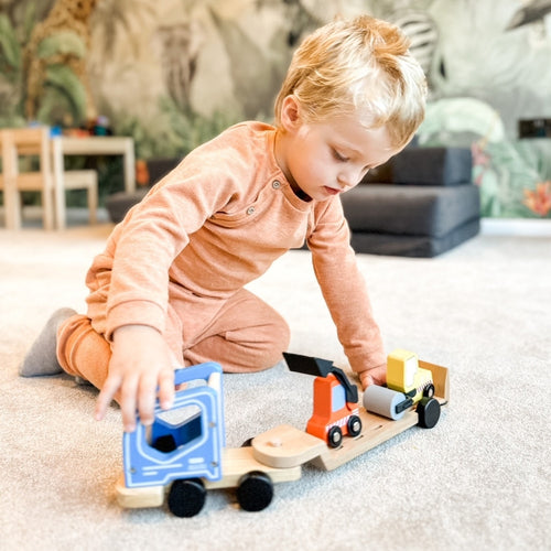  Child pushing construction vehicle toy 
