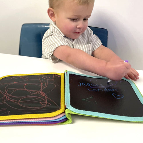  Little boy drawing on the doodle book 