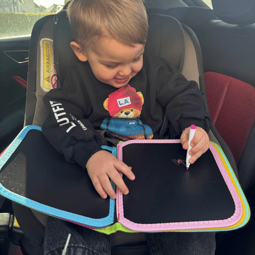  Little boy in car drawing in Dino Doodle Book