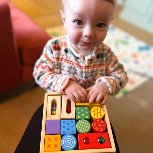  small child playing with the discovery blocks