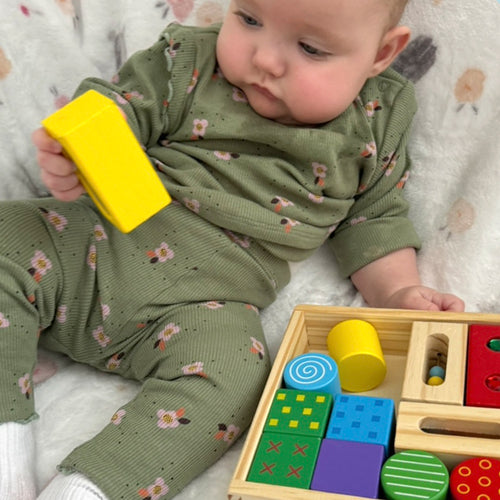  baby playing with the discovery blocks