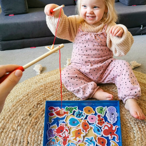  Little girl playing with the educational fishing game 