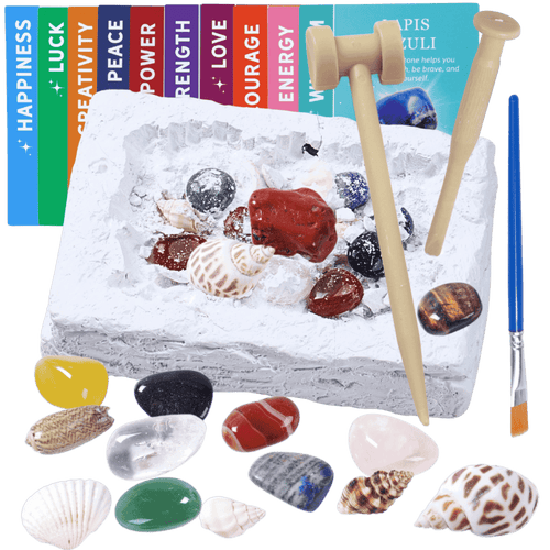 Decorative stone with seashells, stones, and a brush on a black background