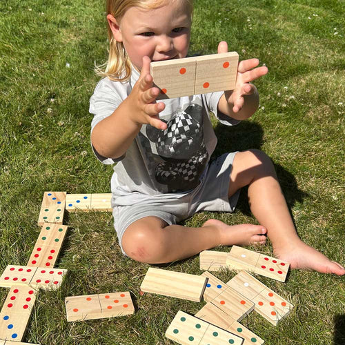 Children playing with the dominoes together 