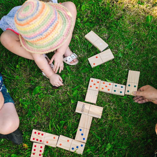 Children playing with the dominoes together 