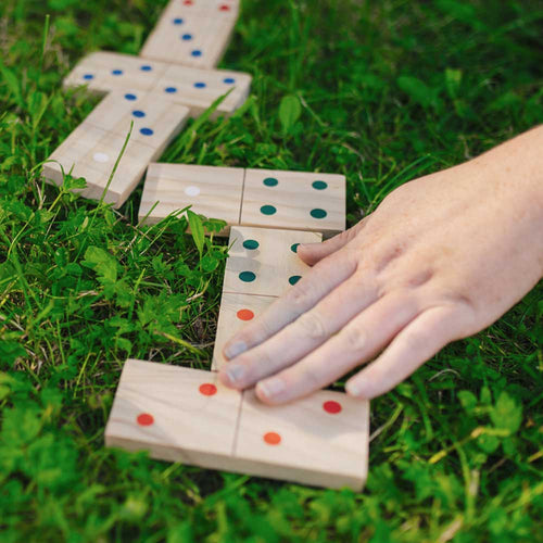 Children playing with the dominoes together 