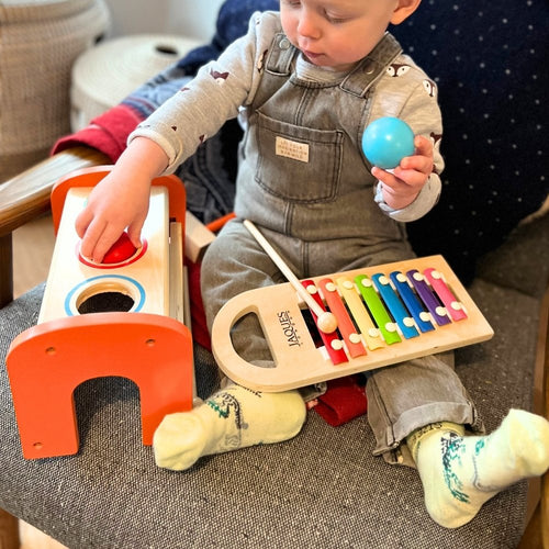  Child playing with musical bench and xylophone