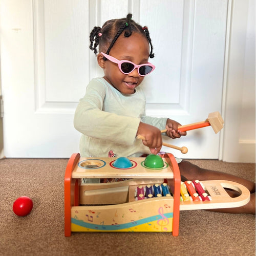  Child playing with musical bench and xylophone 