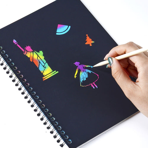  Hand using stylus to scratch rainbow paper 