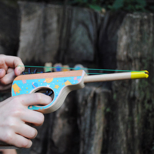 Child loading band into blaster  