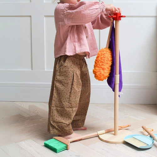  Zoom in of the product stand with girl hanging the items back on the stand