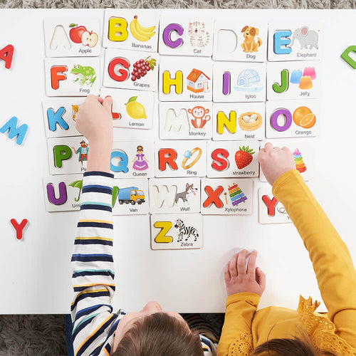 Children playing with alphabet and picture cards on a table  