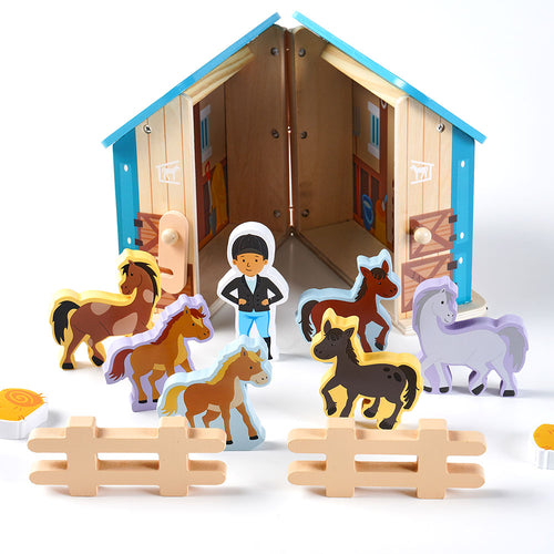  Inside of wooden toy horse stables with wooden horses