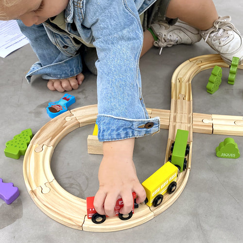  Child playing with wooden train set