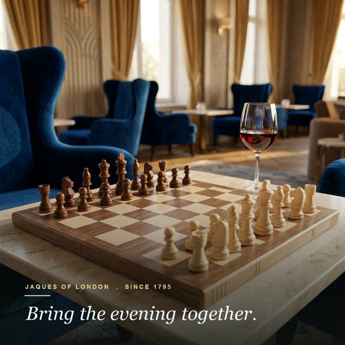 Jaques folding chess set set up on a marble table in a grand luxury hotel lounge 