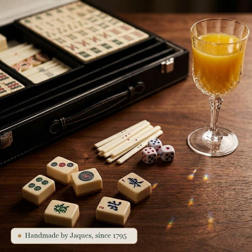 Close detail of the Jaques of London Mahjong tiles, dice and bamboo counting sticks on a walnut table 