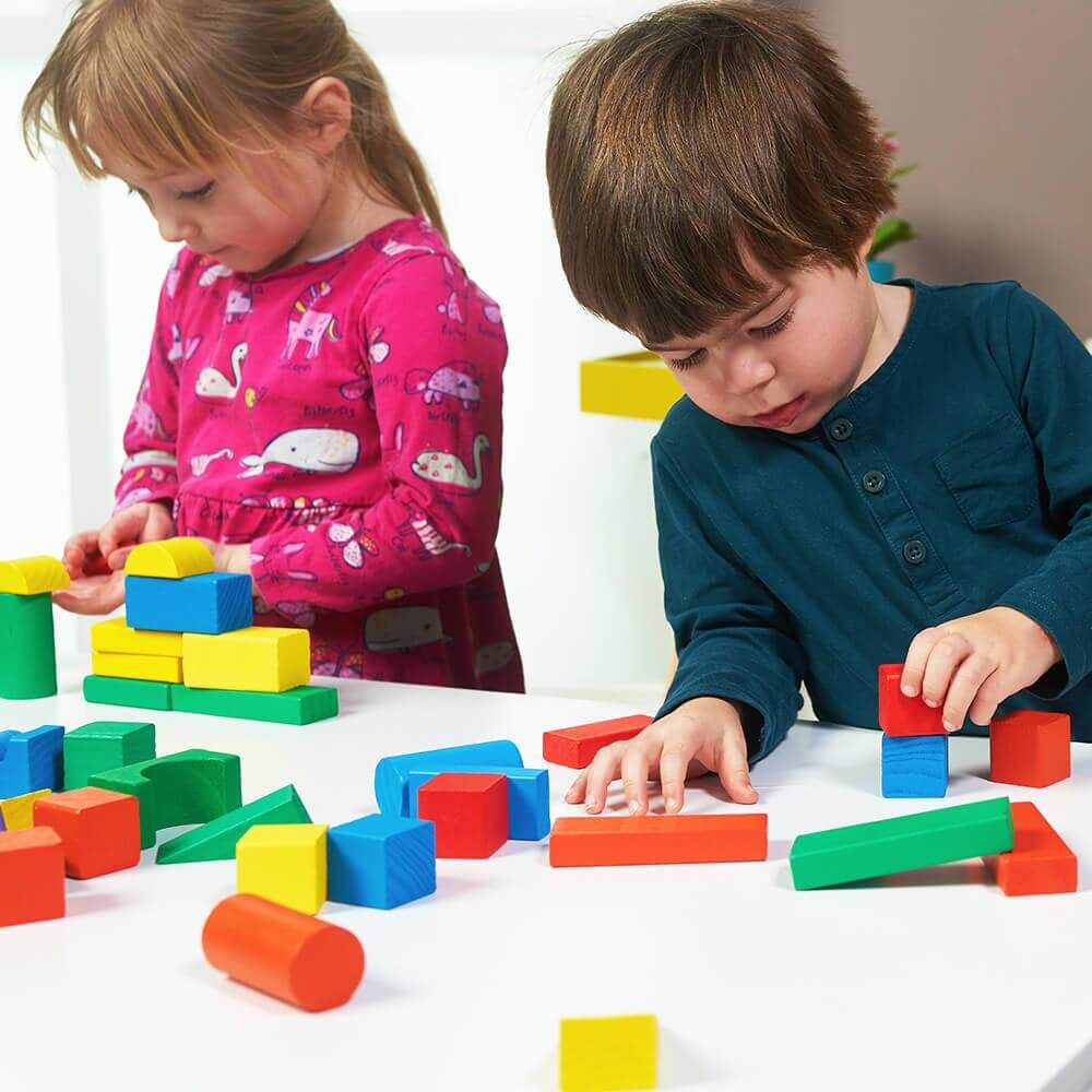  Children building with wooden blocks