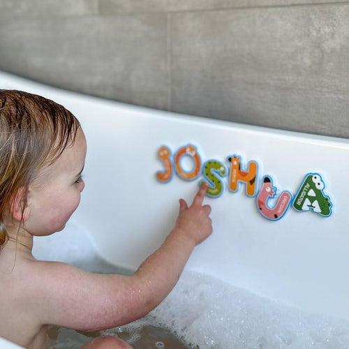  Child-in-bath-pointing-at-bath-letters