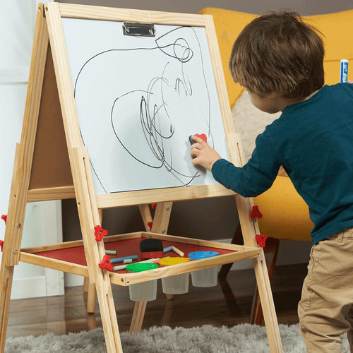  Kids wooden easel - young boy wiping his drawing off the drywipe board