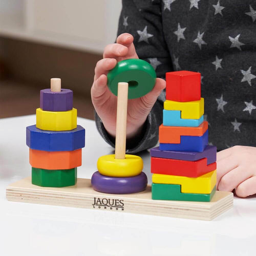  Childs hand stacking ring shapes on wooden stand