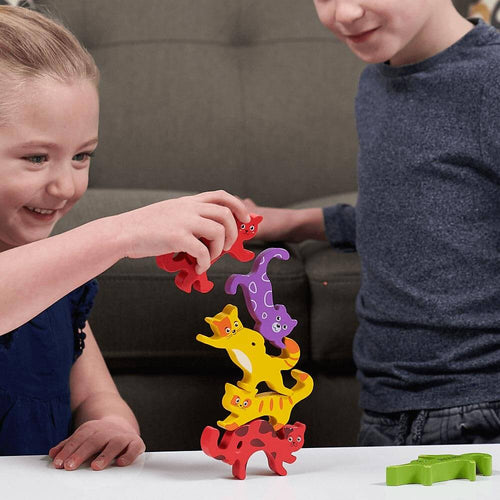 Montessori stacking toy for kids - girl stacking cats on top of each other 