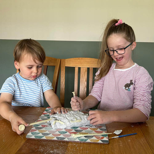 two kids playing with the dino kit