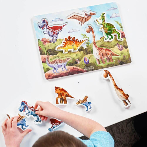  Child playing with dinosaur puzzle pieces 
