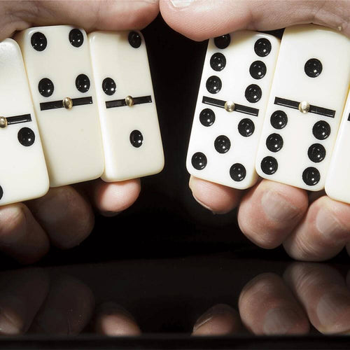  Hands holding double six dominoes
