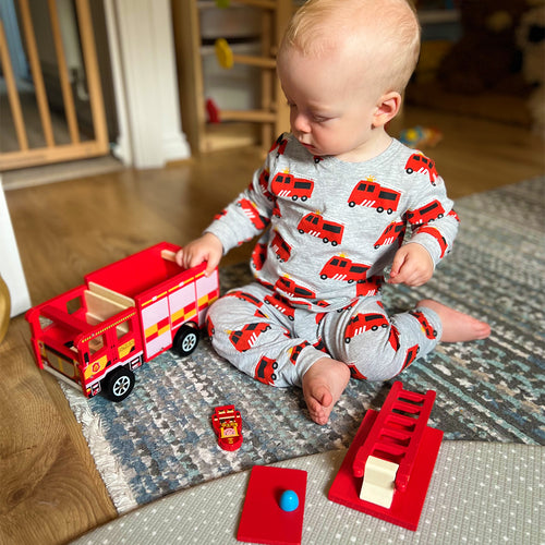  Boy playing with wooden fire engine