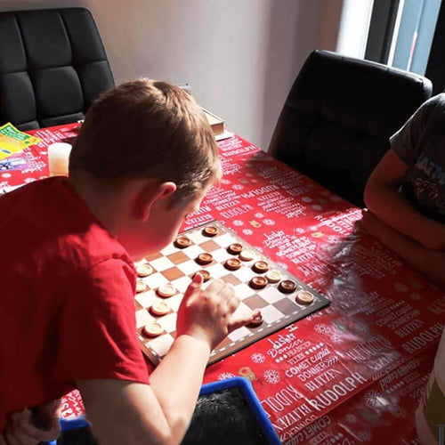  Folding draughts set - 2 boys playing draughts at the table