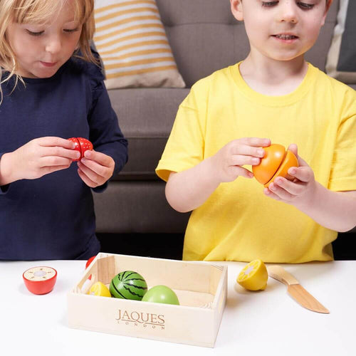  Little girl putting strawberry together and boy putting together the orange