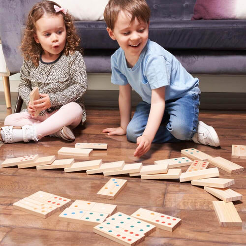 Children playing with giant wooden dominoes 