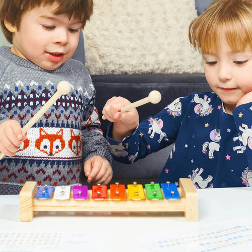  Kids xylophone - girl and boy reading music sheets and playing the xylophone