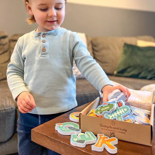  Kids-alphabet-bath-letters---Little-boy-taking-letters-out-of-a-box- 