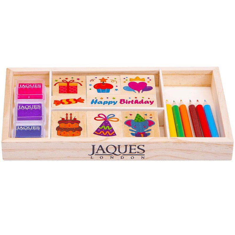 Kids birthday stamp set with ink and pencils in a wooden storage box