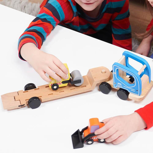 Children playing with low loader construction vehicle toy